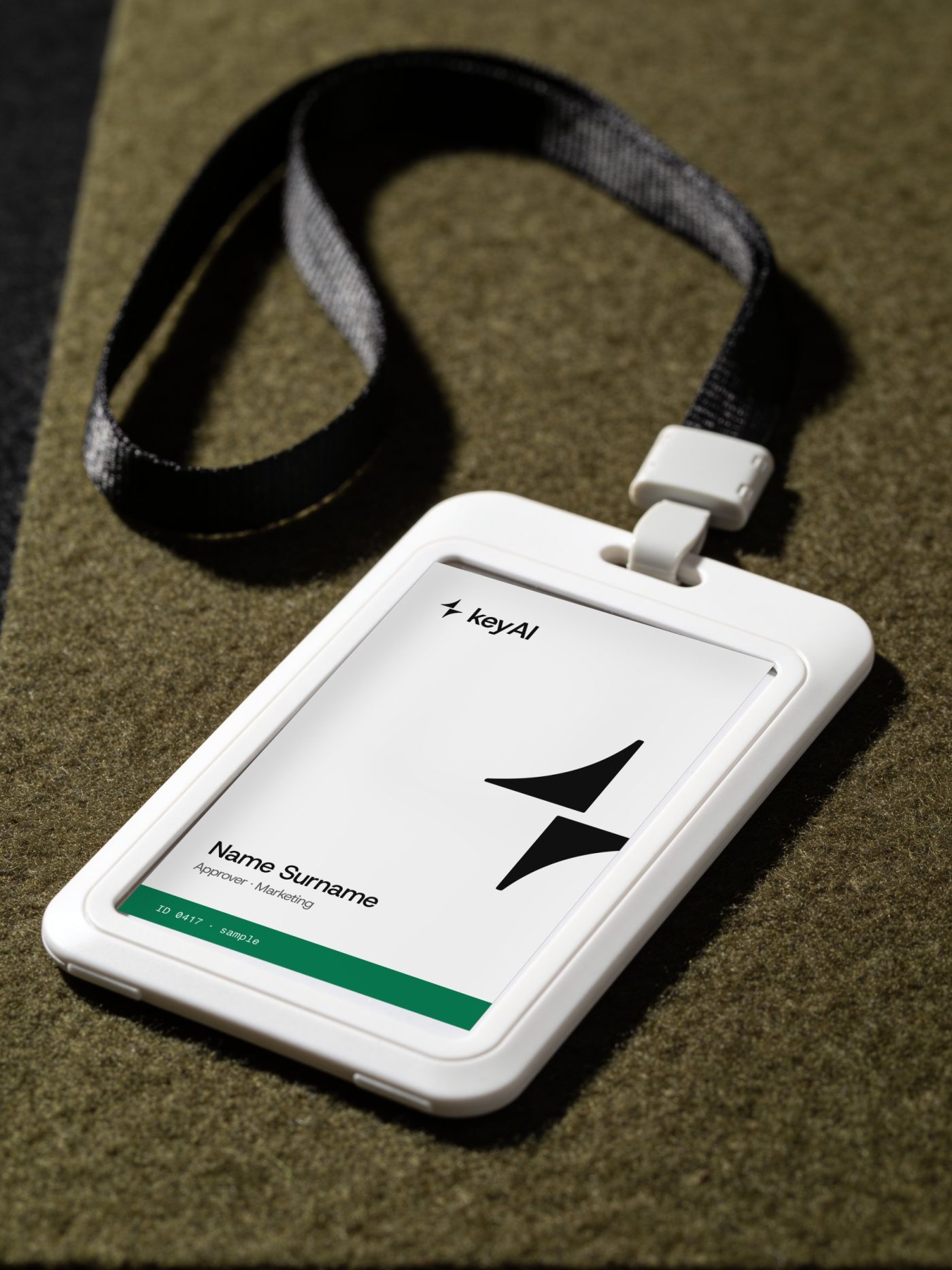 White ID badge with the keyAI logo and a mint approver bar on a black lanyard